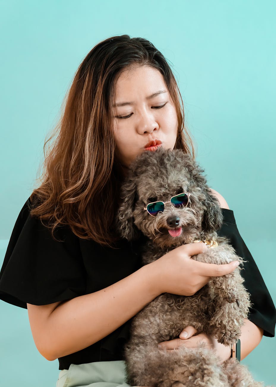 Asian woman cuddling with cute dog